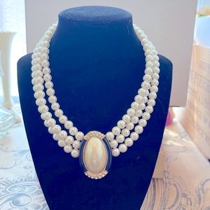 Princess Di inspired look.  3 strands of faux pearls with a oval shaped broach